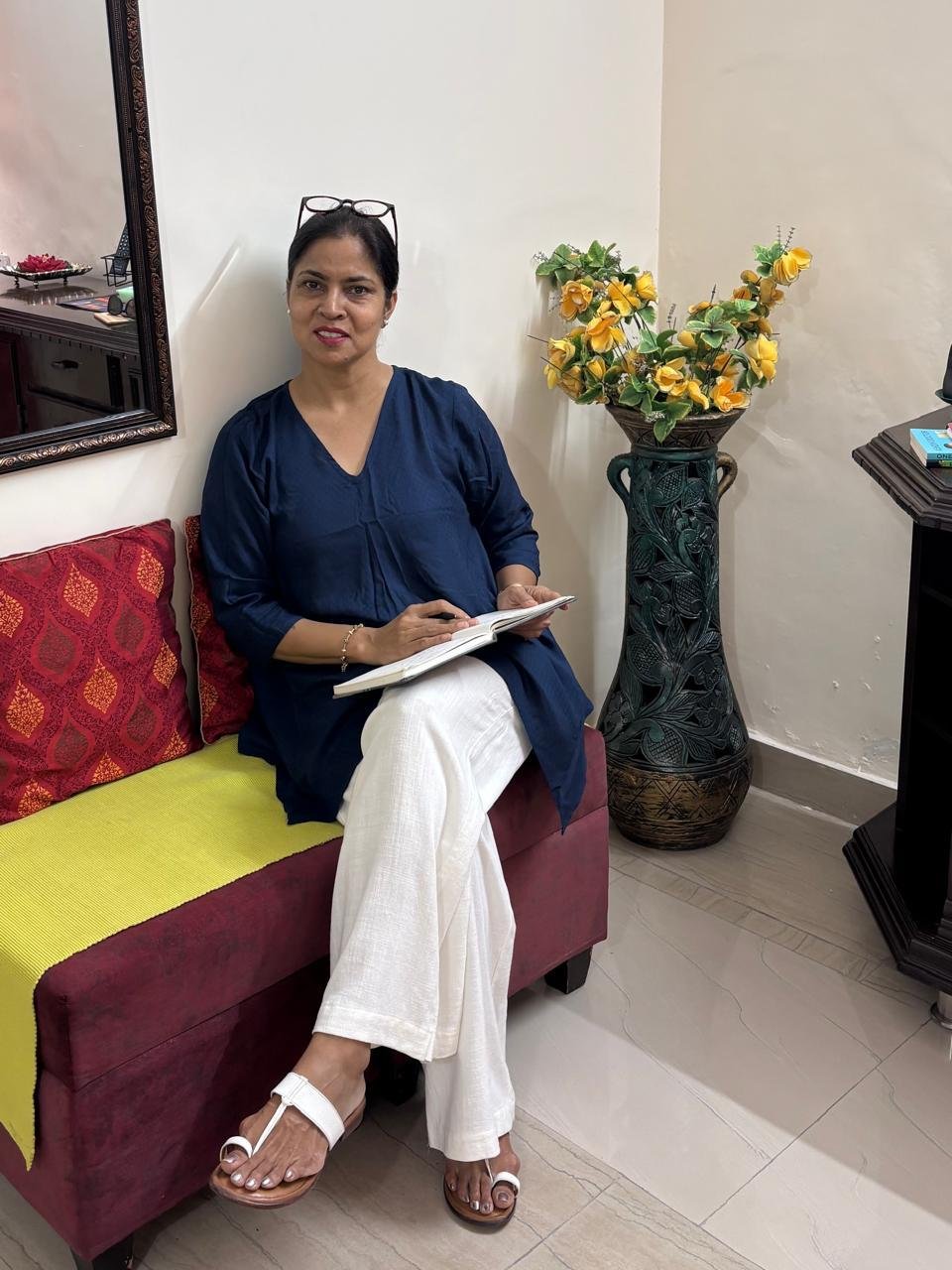 Rajwant Kaur seated with her notebook